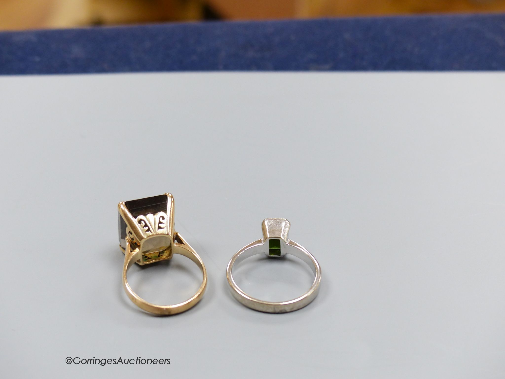 An 18ct white gold and tourmaline ring, size Q, gross 5g, and a 14k gold and smoky quartz ring, size M, gross 7g.